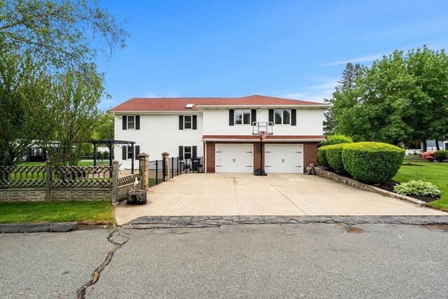 9 Indian Rock Dr, Saugus, MA 01906 - view of front of house featuring a garage, driveway, and brick siding