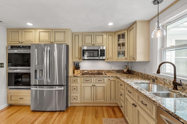9 Indian Rock Dr, Saugus, MA 01906 - kitchen with stainless steel appliances, cream cabinets, a sink, recessed lighting, and a textured ceiling