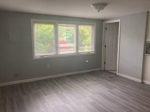 44 Tallawanda Rd, Swansea, MA 02777 - unfurnished bedroom featuring multiple windows, baseboards, and wood finished floors