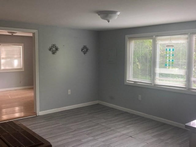 44 Tallawanda Rd, Swansea, MA 02777 - spare room featuring plenty of natural light, wood finished floors, and baseboards