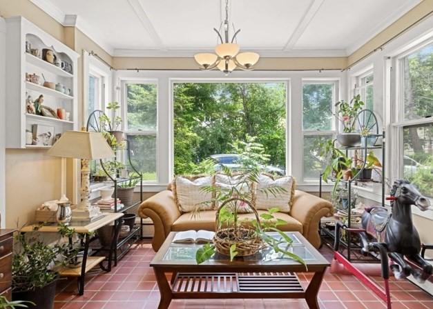 sunroom featuring a chandelier