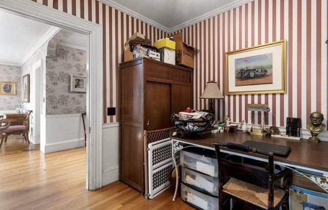 office space with light hardwood / wood-style floors and crown molding