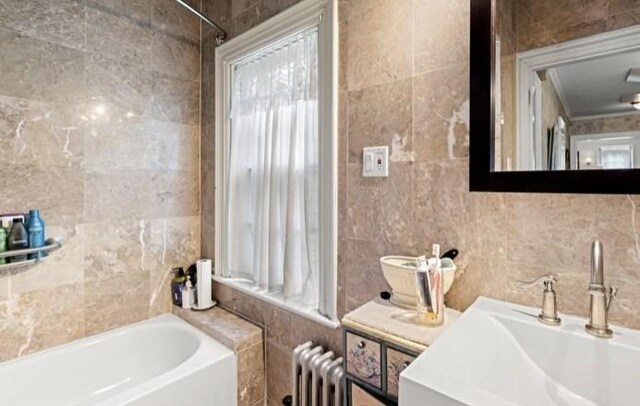 bathroom featuring radiator, shower / bathtub combination, and tile walls