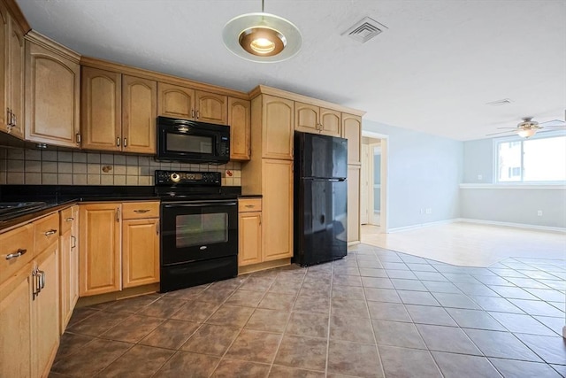 kitchen featuring visible vents, dark tile patterned flooring, black appliances, dark countertops, and decorative backsplash