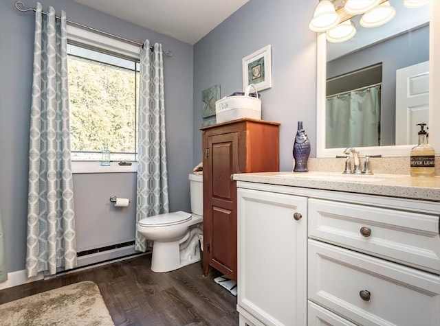 bathroom featuring toilet, wood finished floors, and vanity