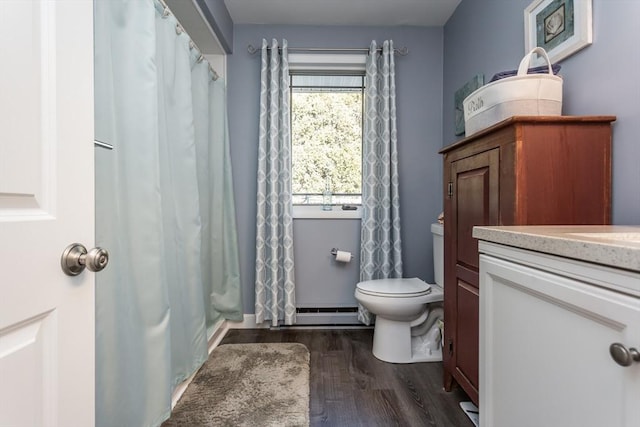 bathroom featuring vanity, curtained shower, wood finished floors, and toilet