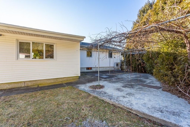 view of property exterior with a patio area