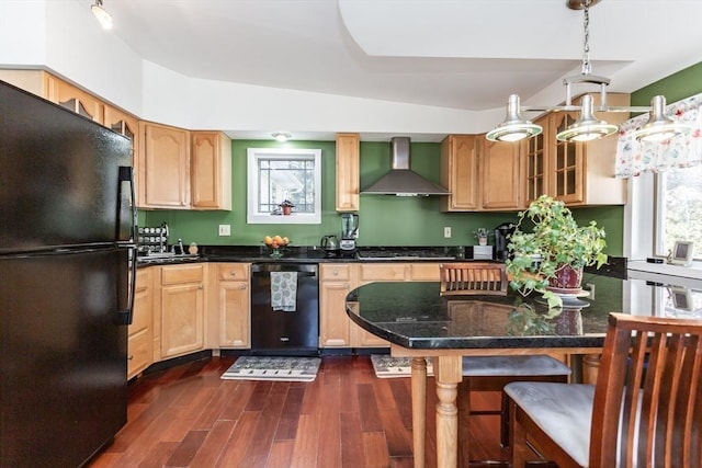 kitchen featuring dark wood-style flooring, glass insert cabinets, light brown cabinets, wall chimney range hood, and black appliances