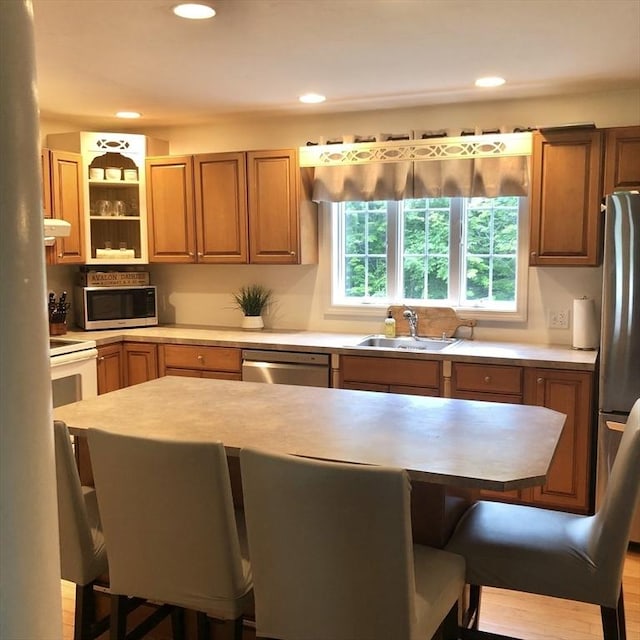 216 Fairbanks St, West Boylston, MA 01583 - kitchen with stainless steel appliances, a kitchen bar, light countertops, recessed lighting, and brown cabinets