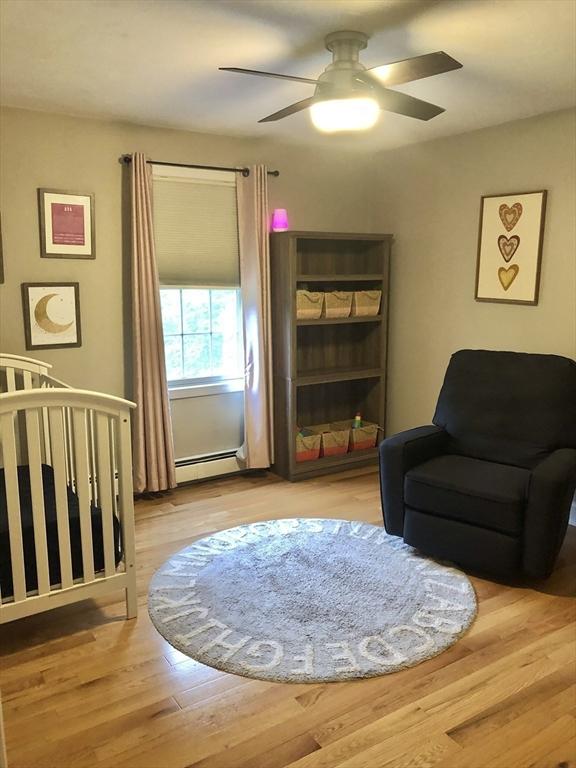 216 Fairbanks St, West Boylston, MA 01583 - living area with a ceiling fan, a baseboard radiator, and wood finished floors