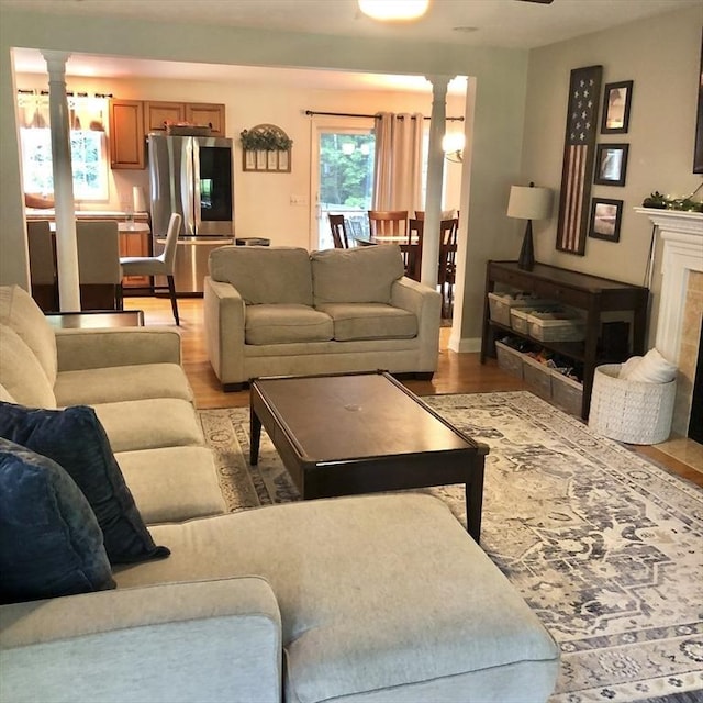 216 Fairbanks St, West Boylston, MA 01583 - living room with light wood-style flooring and decorative columns