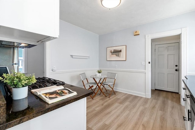 kitchen featuring light hardwood / wood-style floors and white cabinets