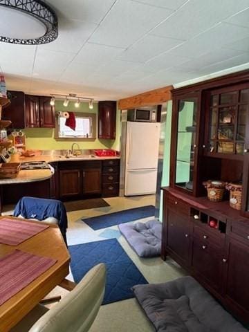 45 Spring St, Lunenburg, MA 01462 - kitchen featuring freestanding refrigerator, track lighting, a sink, light countertops, and dark brown cabinets