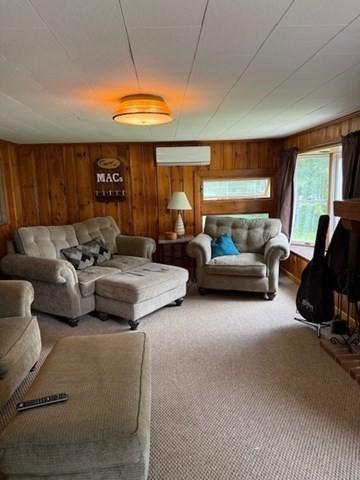 45 Spring St, Lunenburg, MA 01462 - carpeted living room with a wall unit AC and wood walls
