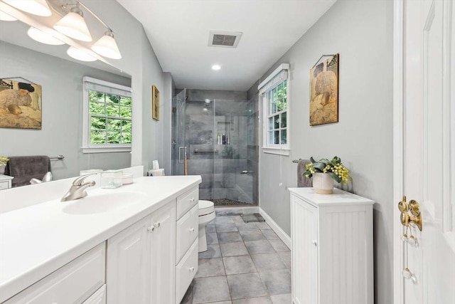 bathroom featuring an enclosed shower, vanity, and toilet