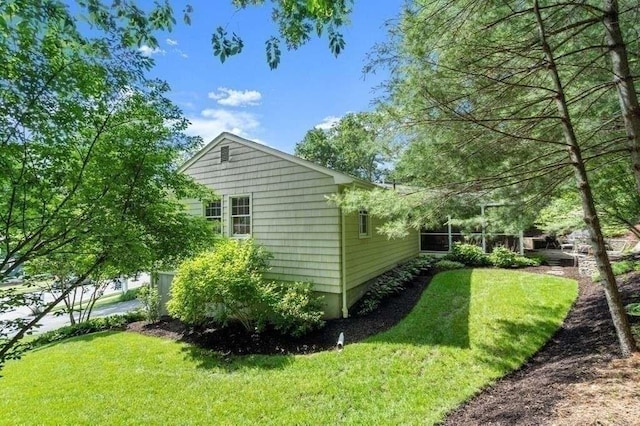 view of side of home featuring a lawn