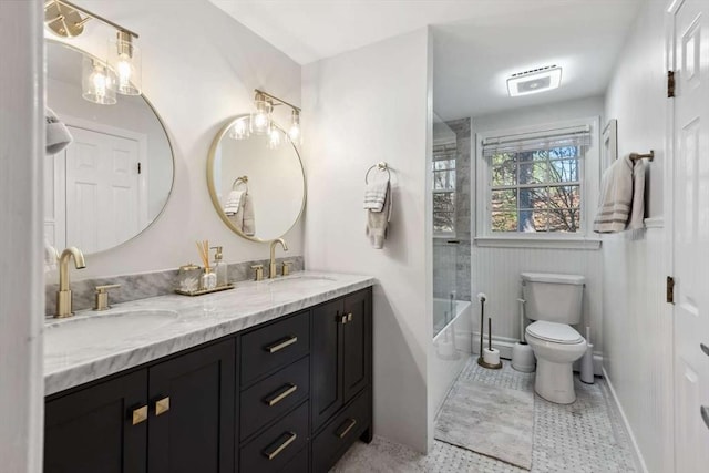 full bathroom featuring toilet, vanity, and shower / bath combination with glass door