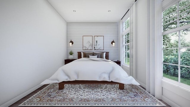 bedroom featuring hardwood / wood-style flooring and multiple windows