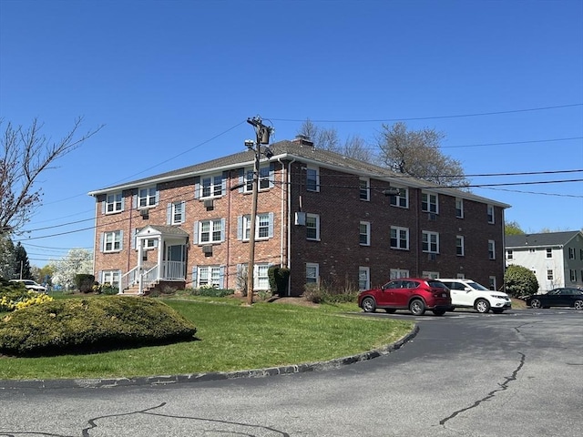view of property featuring uncovered parking