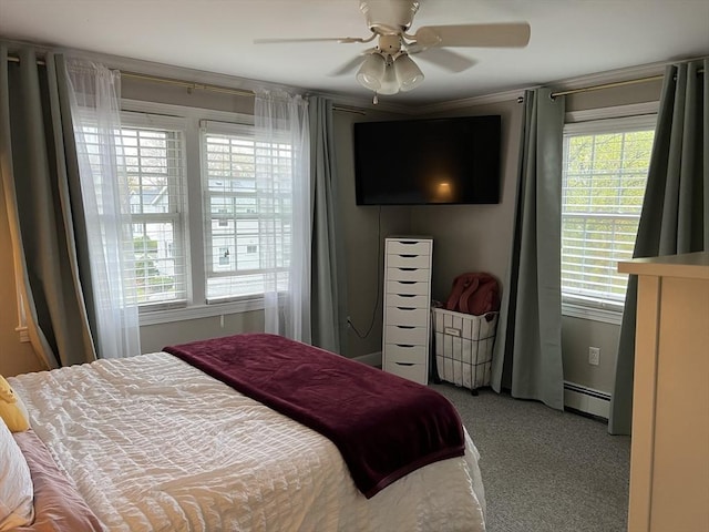 carpeted bedroom featuring ceiling fan and a baseboard heating unit