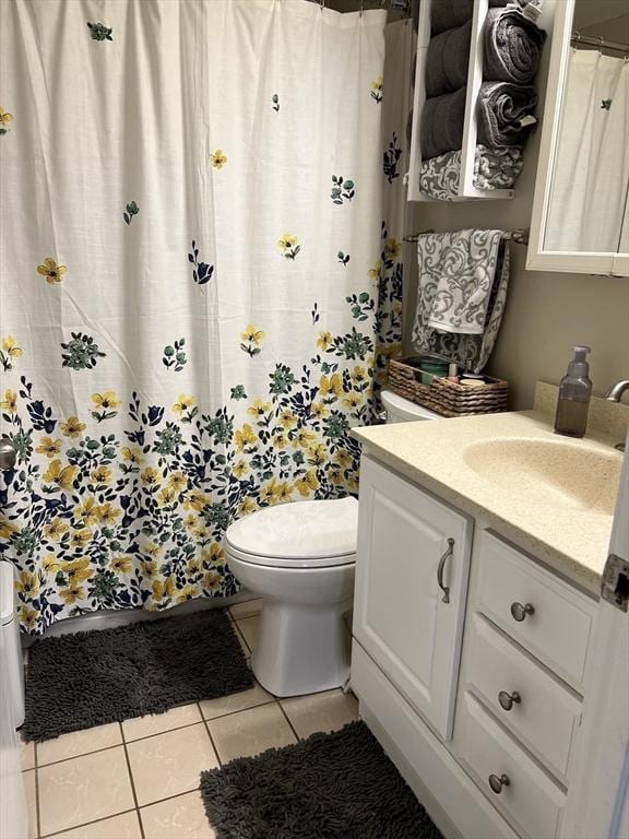 bathroom featuring toilet, tile patterned floors, a shower with shower curtain, and vanity