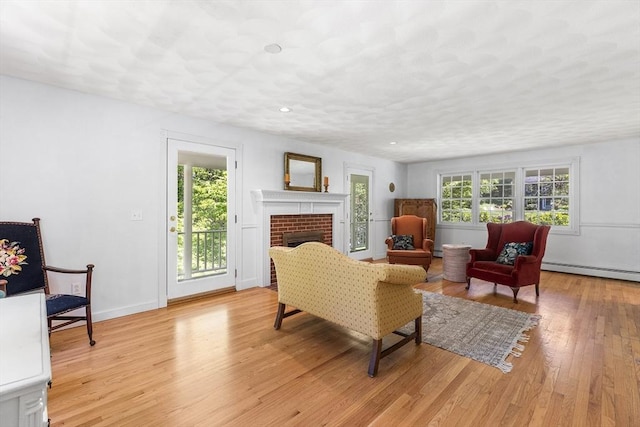 160 Woodland Mead, Hamilton, MA 01982 - living area with a baseboard radiator, light wood-style floors, a brick fireplace, baseboards, and recessed lighting