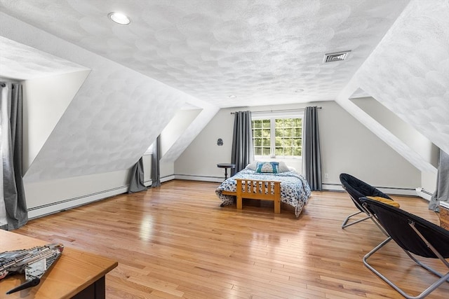 160 Woodland Mead, Hamilton, MA 01982 - bedroom featuring baseboard heating, light wood-style flooring, lofted ceiling, a textured ceiling, and a baseboard heating unit