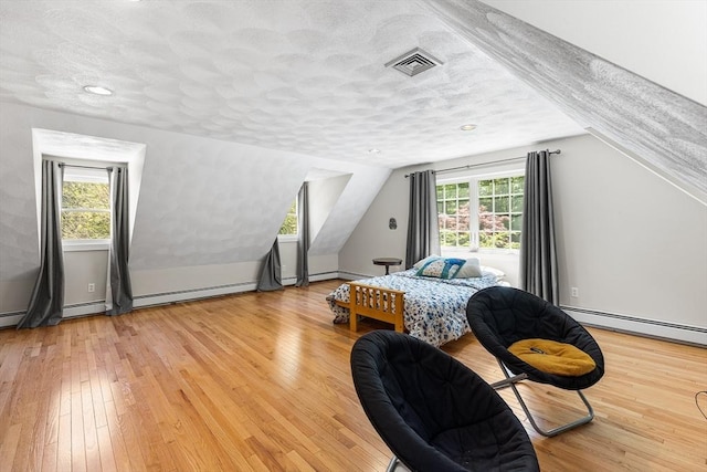 160 Woodland Mead, Hamilton, MA 01982 - bedroom featuring light wood-type flooring, vaulted ceiling, a textured ceiling, and baseboard heating