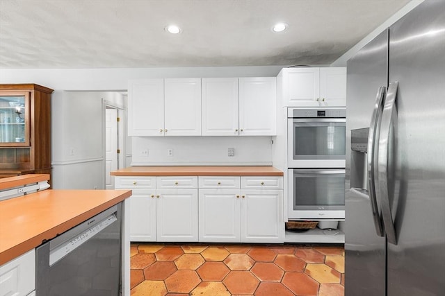 160 Woodland Mead, Hamilton, MA 01982 - kitchen with stainless steel appliances, light countertops, recessed lighting, white cabinetry, and light tile patterned flooring