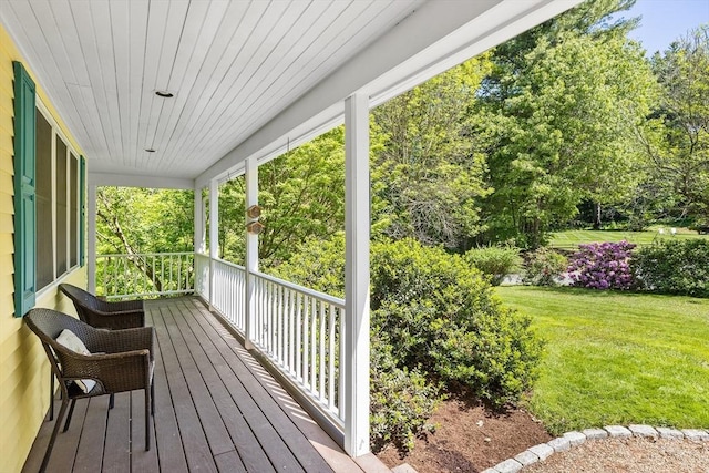 160 Woodland Mead, Hamilton, MA 01982 - wooden porch featuring a lawn and view of wooded area