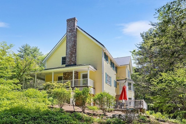 160 Woodland Mead, Hamilton, MA 01982 - view of property exterior featuring a chimney and a porch