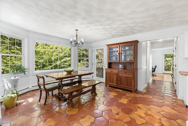 160 Woodland Mead, Hamilton, MA 01982 - dining room featuring healthy amount of natural light, a chandelier, a textured ceiling, and baseboard heating