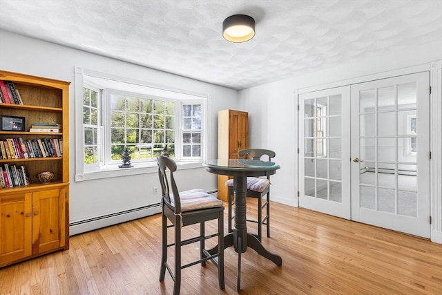 160 Woodland Mead, Hamilton, MA 01982 - dining room featuring a baseboard radiator, light wood-style flooring, and french doors