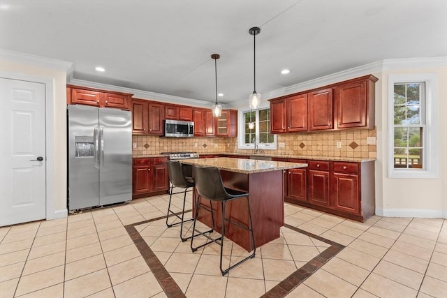 kitchen with light tile patterned flooring, appliances with stainless steel finishes, pendant lighting, decorative backsplash, and light stone countertops