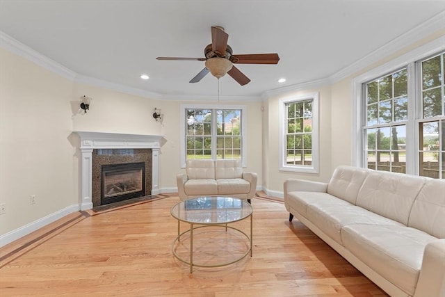 living room featuring ornamental molding, ceiling fan, and light hardwood / wood-style floors