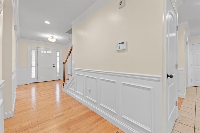 entryway featuring light hardwood / wood-style flooring and ornamental molding