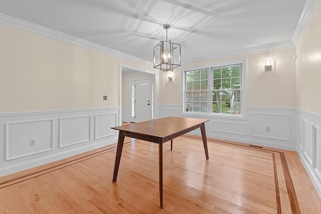 interior space with crown molding, a chandelier, and light hardwood / wood-style flooring