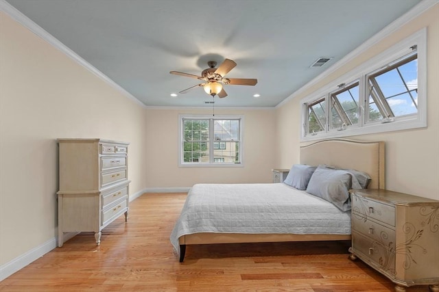 bedroom with crown molding, ceiling fan, and light hardwood / wood-style floors