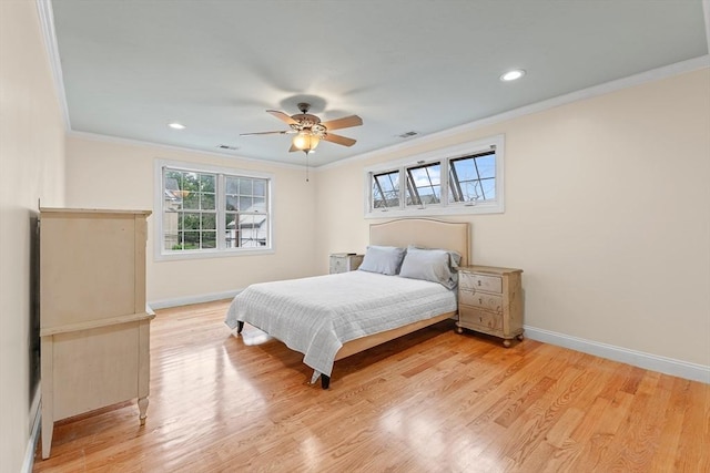 bedroom featuring crown molding, light hardwood / wood-style flooring, and ceiling fan