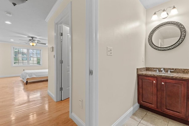 bathroom with vanity, hardwood / wood-style floors, and ornamental molding