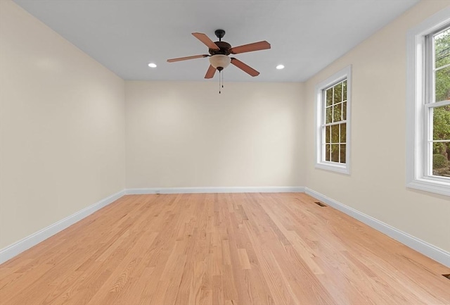 spare room featuring light hardwood / wood-style flooring and ceiling fan