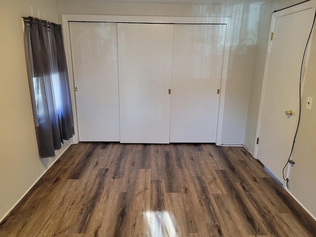 unfurnished bedroom with dark hardwood / wood-style floors