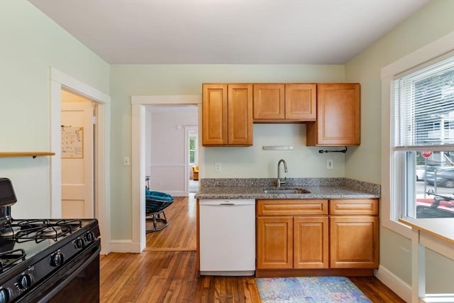 111 Williams St Unit 1, Boston, MA 02130 - kitchen with dishwasher, black gas stove, a sink, wood finished floors, and light stone countertops