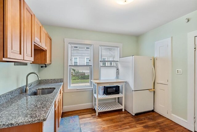 111 Williams St Unit 1, Boston, MA 02130 - kitchen featuring white appliances, a sink, hardwood / wood-style floors, baseboards, and healthy amount of natural light
