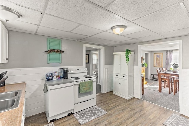 kitchen featuring a drop ceiling, white cabinetry, light hardwood / wood-style floors, and white range with electric cooktop