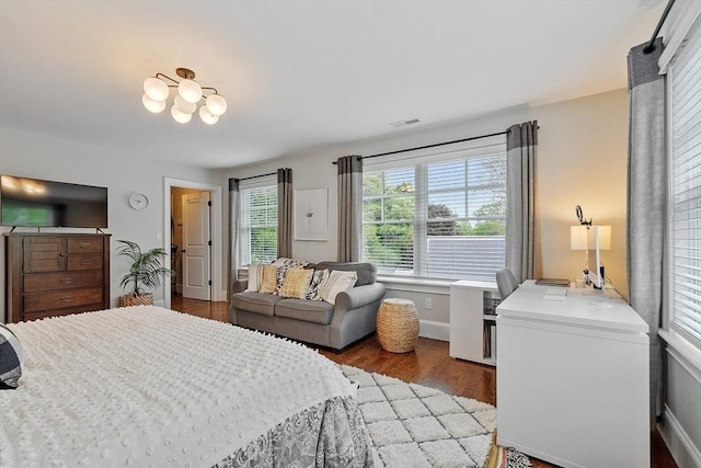 159 Marked Tree Rd, Needham, MA 02492 - bedroom with wood finished floors, baseboards, and a chandelier