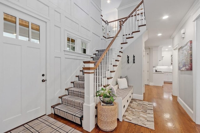 159 Marked Tree Rd, Needham, MA 02492 - entrance foyer with light wood-style flooring, crown molding, recessed lighting, stairway, and baseboards