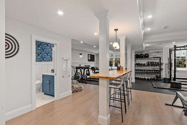 159 Marked Tree Rd, Needham, MA 02492 - dining area with ornate columns, crown molding, light wood-style floors, recessed lighting, and a decorative wall