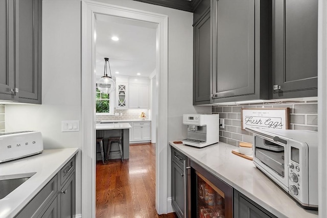 159 Marked Tree Rd, Needham, MA 02492 - kitchen with beverage cooler, wood finished floors, tasteful backsplash, recessed lighting, and gray cabinets