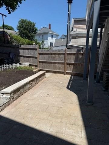 9 Foster St Unit 1, Gloucester, MA 01930 - fenced backyard featuring a patio area
